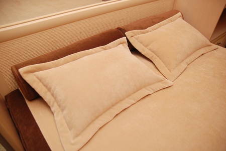 pillows on a bed in a bedroomの写真素材
