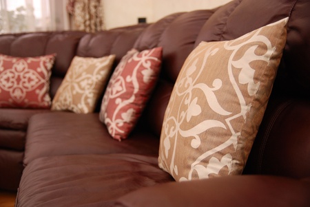 pillows on a brown leather sofaの写真素材