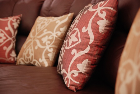 pillows on a brown leather sofaの写真素材