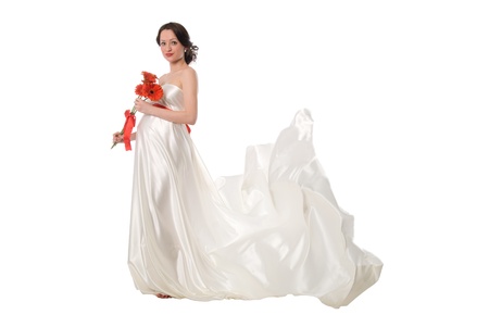 Pregnant woman with a dress fluttering from a windの写真素材
