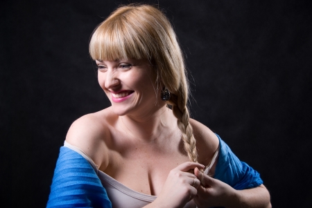 Portrait of beautiful blonde braiding a plait- isolated on whiteの写真素材
