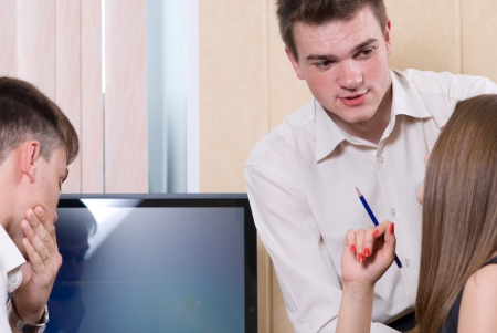 Young people solve a problem about the monitor.の写真素材