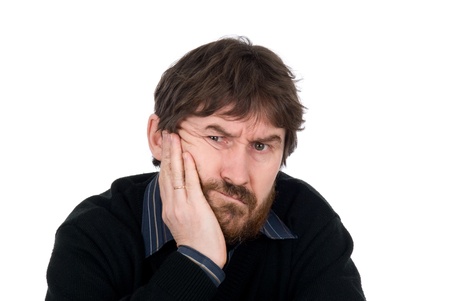 Portrait of the thoughtful bearded man with a hand on a cheek.Isolated on a white backgroundの写真素材