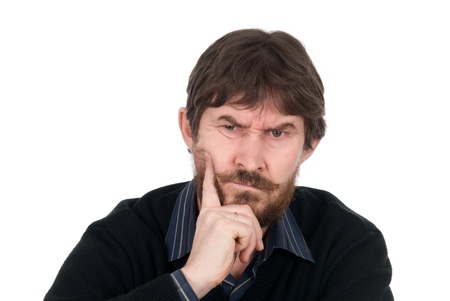 Portrait of the thoughtful bearded man with a finger on a cheek.Isolated on a white backgroundの写真素材
