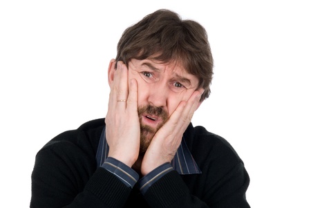 Portrait of upset man with hands on cheeks.Isolated on a white backgroundの写真素材