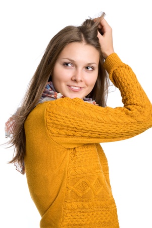Portrait of a beautiful young girl with blond hair- isolated on white.A girl in a sweaterの写真素材