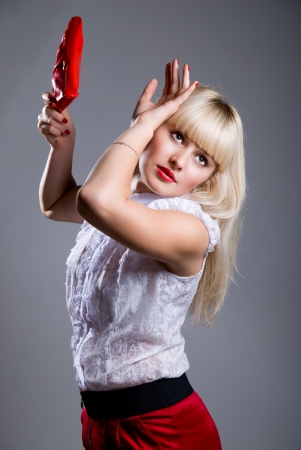 Portrait of fashion model holding little purse on gray backgroundの写真素材