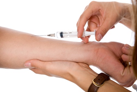 vaccine injection in hand isolated on whiteの写真素材