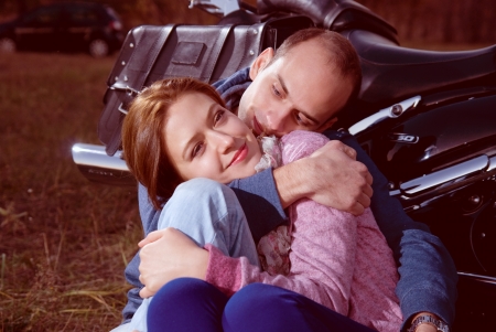 Beautiful couple sitting on a motorcycle.の写真素材