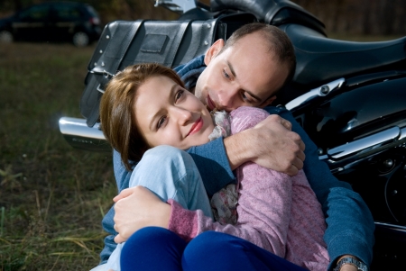 Beautiful couple sitting on a motorcycle.の写真素材
