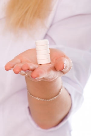 Woman hand holding pills on whiteの写真素材