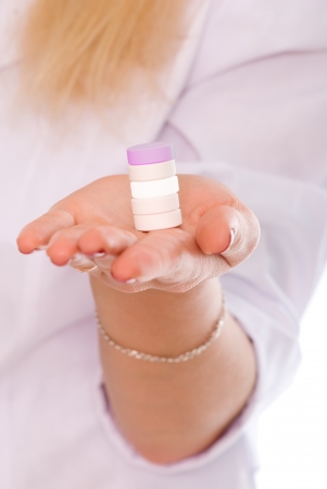 female holding pills in hand.の写真素材