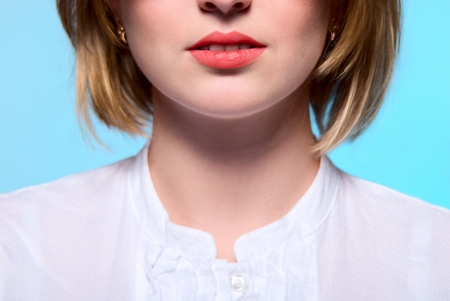 red lips, close-up portrait on a blue backgroundの写真素材