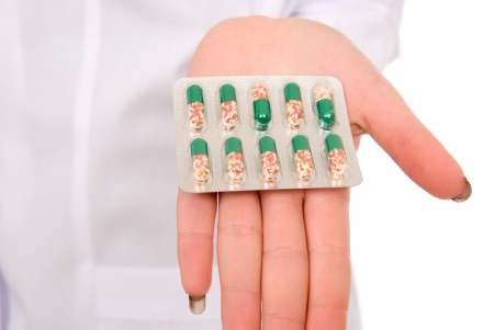 Close-up of pills in her hand.isolated against white backgroundの写真素材