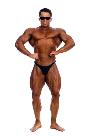 Muscled male model in glasses posing in studio on a white backgroundの写真素材