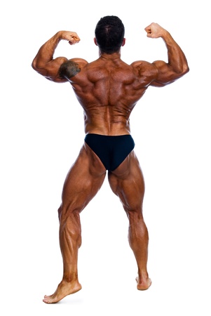 Muscled male model posing in studio on a white background.Athlete's backの写真素材