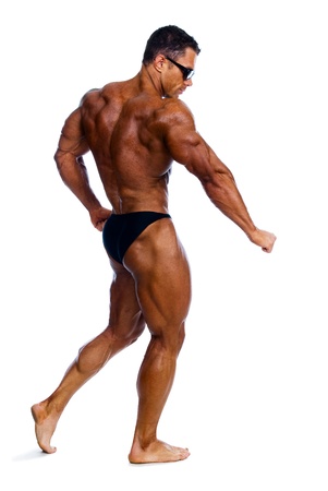 Bodybuilder showing his muscles on a white background.In glassesの写真素材