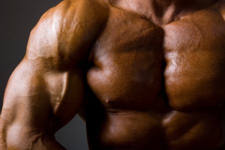 Muscular male torso on dark background.の写真素材