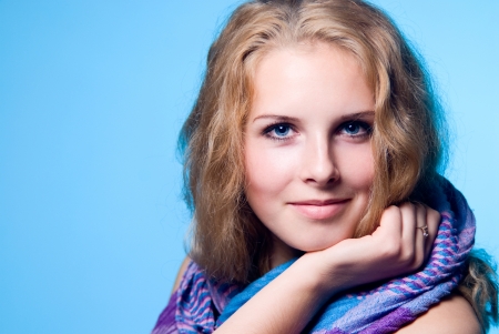 Close-up portrait of caucasian young woman isolated on blue backgroundの写真素材