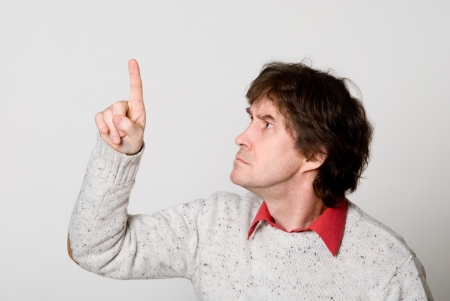 Man pressing / pushing button isolated on light background. Caucasian male in his 40sの写真素材