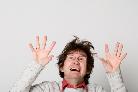 Shocked man looking up with his mouth open isolated against white backgroundの写真素材