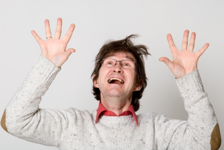 Shocked man looking up with his mouth open isolated against white backgroundの写真素材