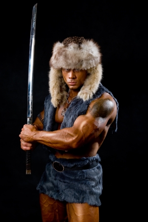 Male warrior with sword raised. The image of the barbarianの写真素材