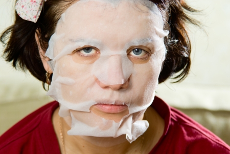 Portrait  close-up woman applying rejuvenating facial mask on her face.の写真素材