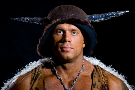 Male warrior in a headdress with horns on a black backgroundの写真素材
