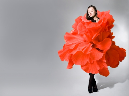 Thoughtful beautiful girl in a dress of rose.の写真素材