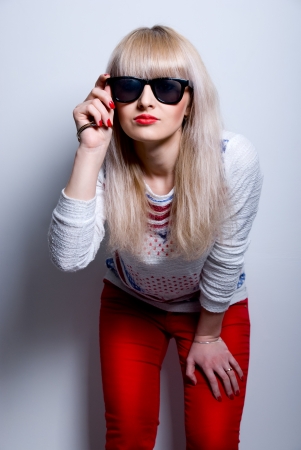 The fashion girl in sunglasses, light backgroundの写真素材