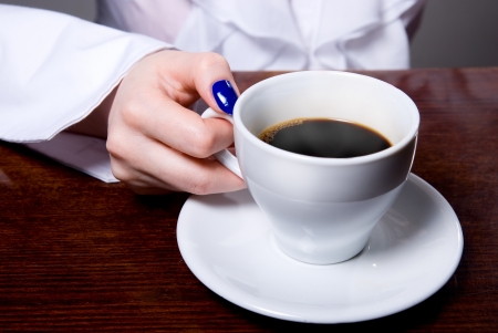Woman holding cup of coffee on background.の写真素材