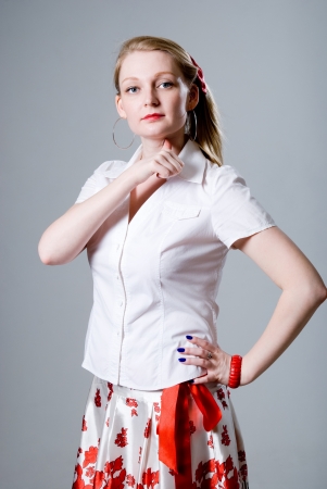 A beautiful woman with a thumb to the throat. gesture executedの写真素材