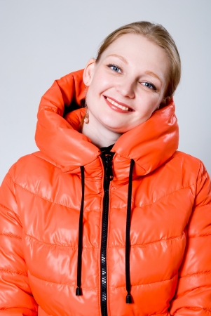Happy girl in the orange jacket. Cold autumn winter seasonの写真素材