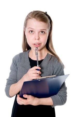 Young thoughtful girl with a clipboard and pen. Isolated on white backgroundの写真素材
