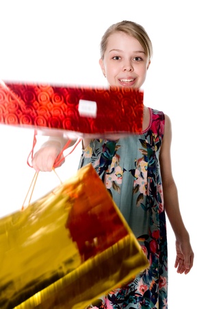 Shopper woman holding shopping bags. Shopper girl holding shopping bags smiling happy fresh. Isolated on white backgroundの写真素材