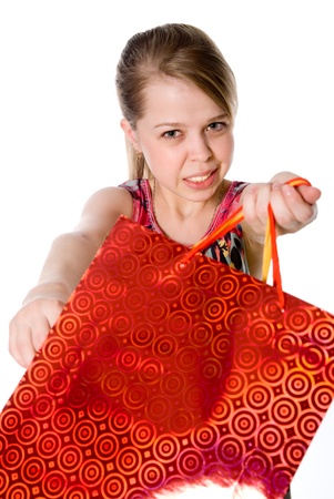 A girl holds a shopping bag. Isolated on white backgroundの写真素材