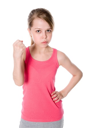 Gloomy portrait young girls, shows fist on white backgroundの写真素材