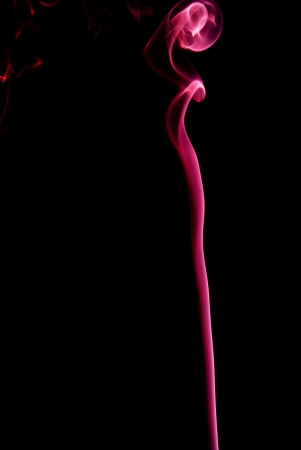 Red plume of smoke on a black background.の写真素材