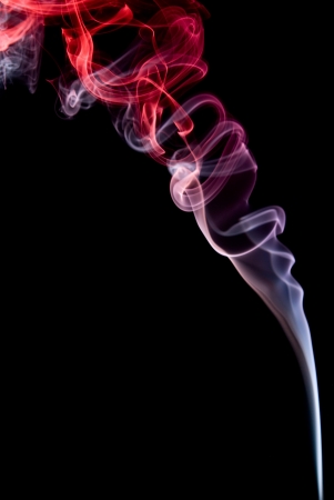 Coloured smoke isolated on black background.の写真素材