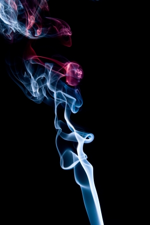 Multi-colored smoke on a black background.の写真素材