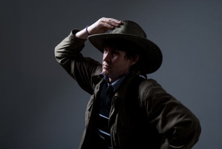 A traveler in a hat looking to the side.の写真素材