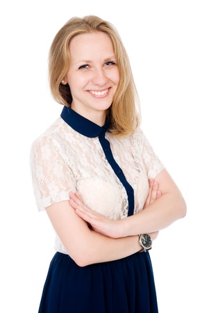 Portrait of young smiling female standing with folded hands over white backgroundの写真素材