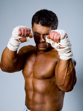 Kick-boxer in fighting stance with his hands upの写真素材