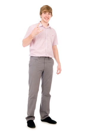 portrait of young man doing a rock and roll symbol over white backgroundの写真素材