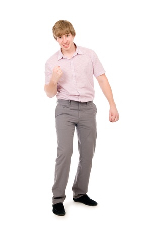 Cute young guy clenching his fist in triumph, isolated over white, success conceptの写真素材