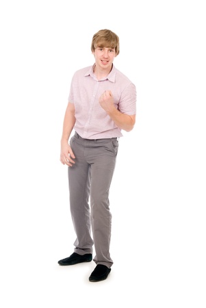 Cute young guy clenching his fist in triumph, isolated over white, success conceptの写真素材