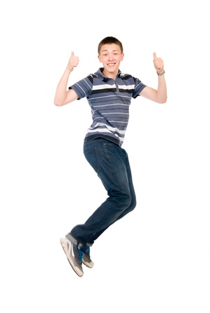Young man jumping with raised thumbs up. Isolated on white backgroundの写真素材