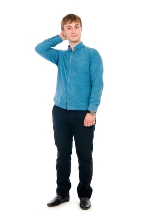 Pensive young man in full view. Isolated on white backgroundの写真素材