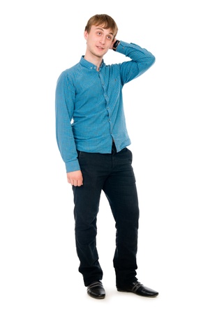 Pensive young man in full view. Isolated on white backgroundの写真素材